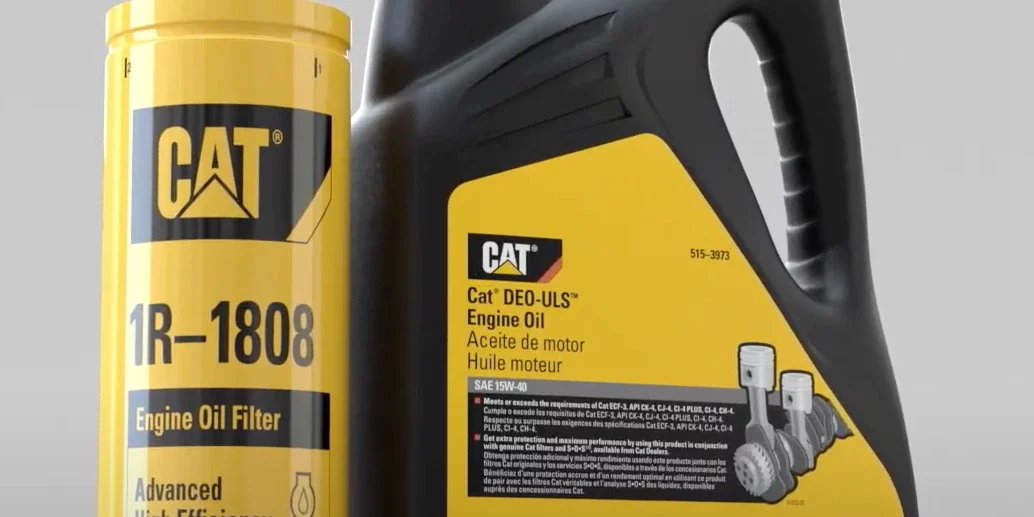 CAT engine oil filter next to a carton of CAT oil.