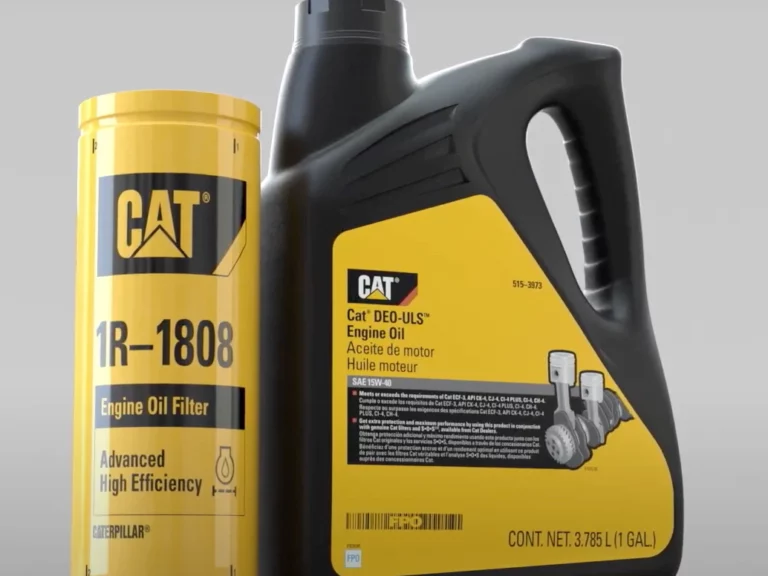 CAT engine oil filter next to a carton of CAT oil.