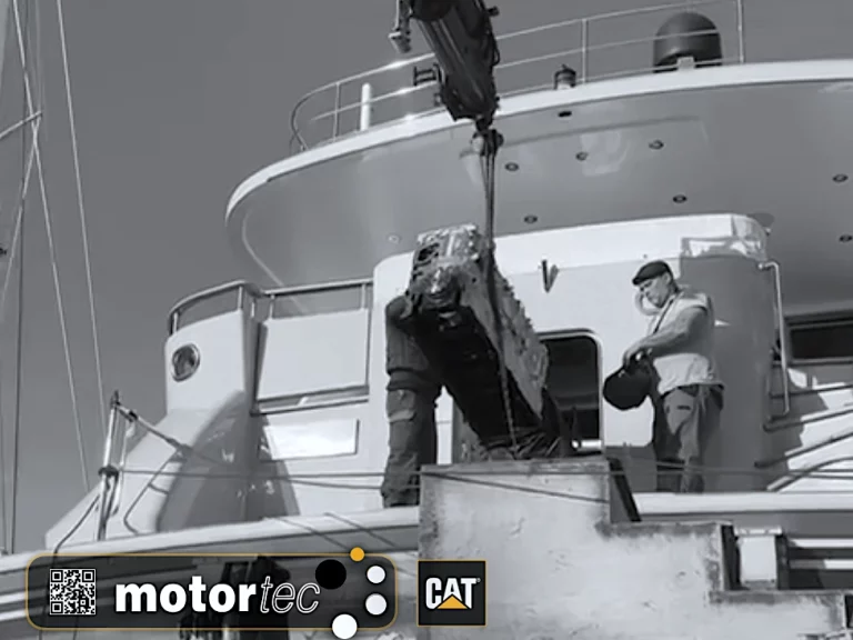 Motortec team using a crane to work on the C18 Caterpillar engine