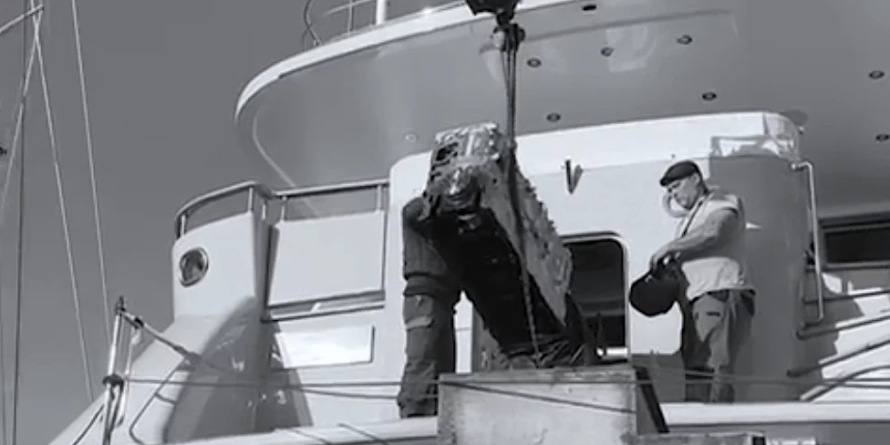 Motortec team using a crane to work on the C18 Caterpillar engine