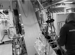 The Motortec team servicing Caterpillar engine parts in black and white.