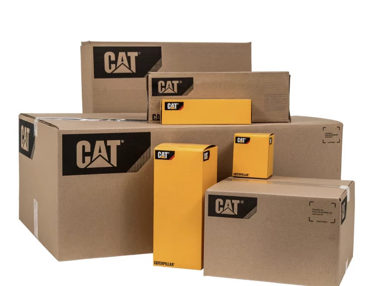 A collection of cardboard boxes filled with genuine Caterpillar yacht engine parts.