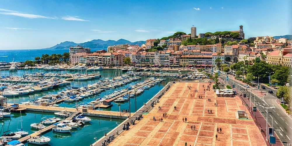 Sunny day at Vieux - Port Cannes with yachts berthed on bright blue water
